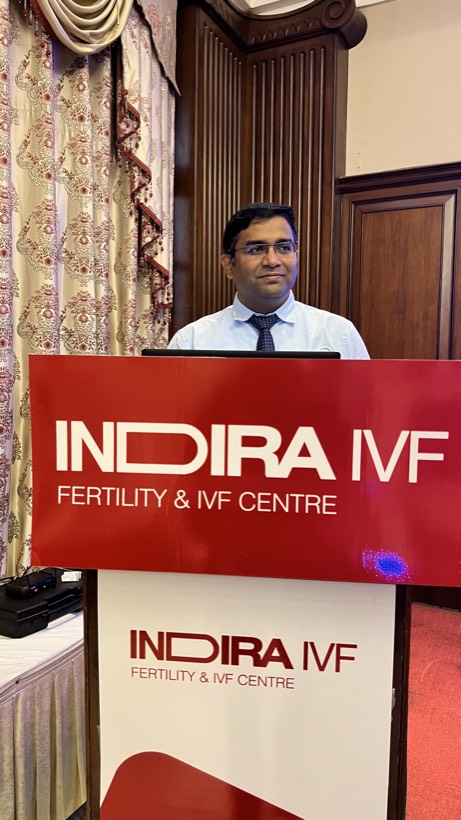 At the podium, Indira IVF continuing medical education session