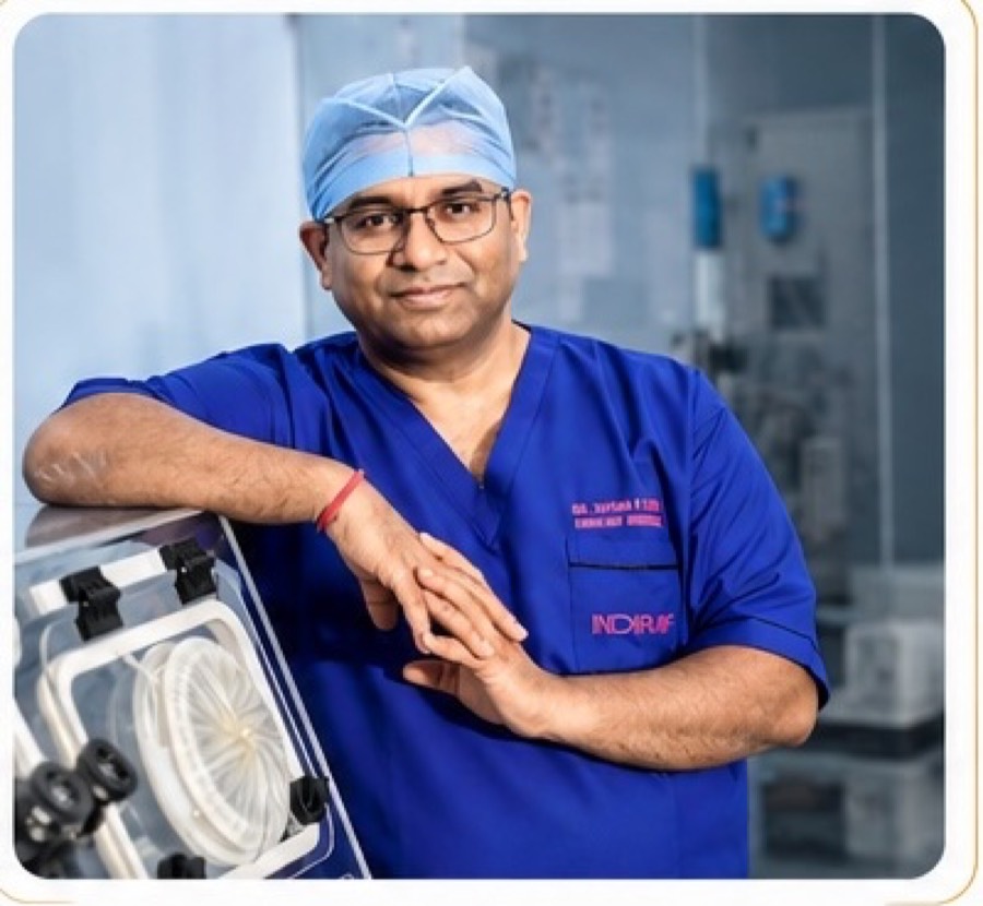Dr Shyam N Gupta in surgical scrubs beside an embryo incubator